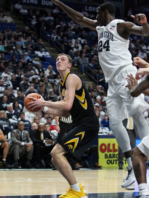 Iowa Hawkeyes forward Jack Nunge (2) looks to shoot as Penn State Nittany Lions forward Mike Watkins (24) defends during the second half at Bryce Jordan Center. Penn State defeated Iowa 82-58.