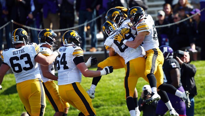 Iowa football players celebrate one of Akrum Wadley's four touchdowns against Northwestern on Oct. 17.  After a bye week, Wadley is No. 1 at running back on the depth chart, with Derrick Mitchell Jr. and LeShun Daniels Jr. backing him up.