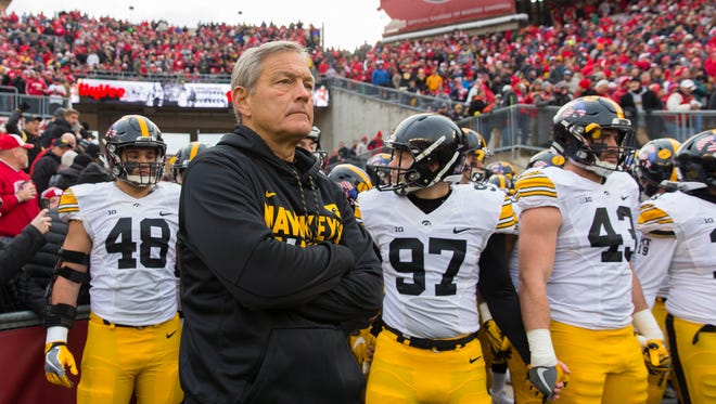 Nov 11, 2017; Madison, WI, USA; Iowa Hawkeyes head coach Kirk Ferentz (C) stands prepares to take the field with his players prior to their game against the Wisconsin Badgers at Camp Randall Stadium. Mandatory Credit: Jeff Hanisch-USA TODAY Sports