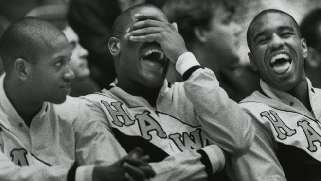 From left, the Hawkeyes' B.J. Armstrong, Ed Horton and Roy Marble enjoy a moment on the bench during a game.