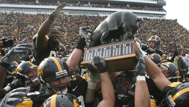 Rafael Eubanks (52) and the rest of the Hawkeyes celebrate with the Floyd  of Rosedale trophy after defeating Minnesota 21-16,  Saturday November 10, 2007, at Kinnick Stadium, in Iowa City, Iowa.