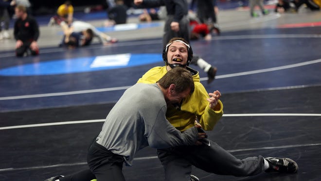 Iowa's Spencer Lee wrestles associate head coach Terry Brands during a practice session at the NCAA Wrestling Championships at Quicken Loans Arena in Cleveland, Ohio on Wednesday, March 14, 2018.
