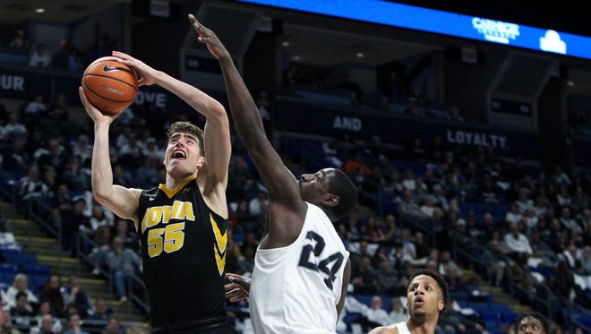 Iowa Hawkeyes forward Luka Garza (55) shoots as Penn State Nittany Lions forward Mike Watkins (24) defends during the second half at Bryce Jordan Center. Penn State defeated Iowa 82-58.