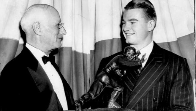 Nile Kinnick, right, holds the Heisman Trophy in 1939. Listen to Kinnick ' s legendary Heisman acceptance speech: http://bit.ly/32nGJwG.