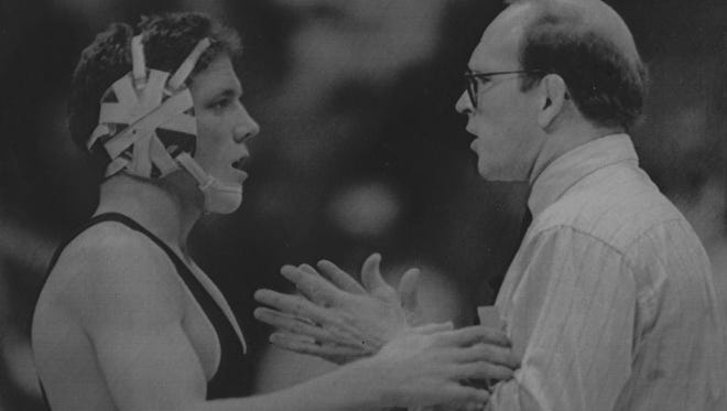 In this 1991 photo, Iowa wrestling coach Dan Gable confers with Terry Steiner.
