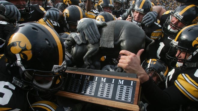 The Iowa Hawkeyes mob over the Floyd of Rosedale trophy after defeating Minnesota 21-16,  Saturday November 10, 2007, at Kinnick Stadium, in Iowa City, Iowa.