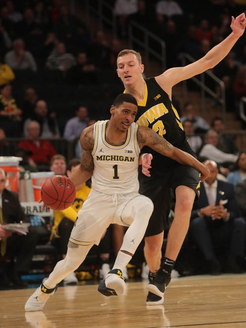Michigan guard Charles Matthews drives against Iowa forward Jack Nunge during the first half of the second round game in the Big Ten tournament on Thursday, March 1, 2018, at Madison Square Garden.
