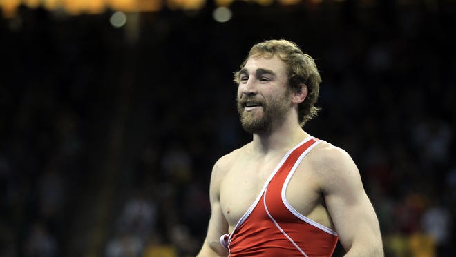 Former Hawkeyes Daniel Dennis smiles after beating Anthony Ramos in the 125.5-pound (57 kilo) freestyle championships at the U.S. Wrestling Olympic Team Trials at Carver-Hawkeye Arena on Sunday, April 10, 2016.
