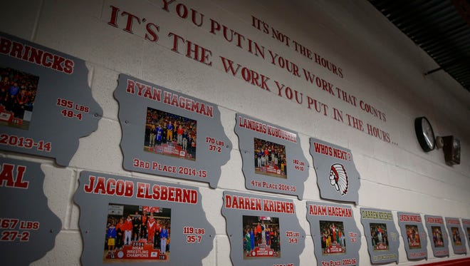 The wall of state place winners at the South Winneshiek High School wrestling room in Calmar, Iowa, where junior Felicity Taylor hopes to be a permanent fixture of.