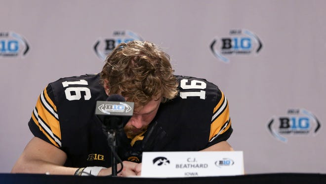 Iowa Hawkeyes quarterback C.J. Beathard (16) reacts during a press conference following Saturday's 16-13 loss to Michigan State in the Big Ten Conference championship game.