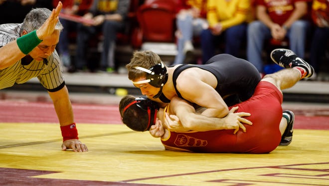 Iowa State University's Sinjin Briggs gets pinned by Iowa's Spencer Lee in the 125-pound match Sunday, Feb. 18, 2018, during their wrestling meet at the Hilton Coliseum in Ames.