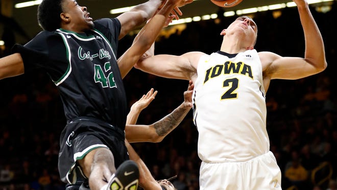 Iowa forward Jack Nunge (2) fights for a rebound with Chicago State forward Jalen Stephens-Holmes, left, during the second half of an NCAA college basketball game, Friday, Nov. 10, 2017, in Iowa City, Iowa. Iowa won 95-62. (AP Photo/Charlie Neibergall)