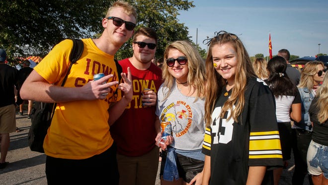 Cyclones fans Jack Miller, from left, Connor Miller and Tia Ewalt pose with Hawkeye fan Brooklynn Porter while tailgating prior to the CyHawk Series game between Iowa and Iowa State on Saturday, Sept. 9, 2017, at Jack Trice Stadium in Ames, Iowa.