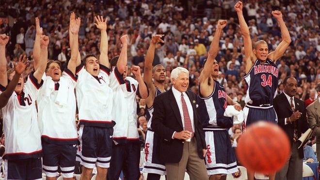 The Arizona bench and coach Lute Olson react during the Wildcats' NCAA title game against Kentucky in 1997.