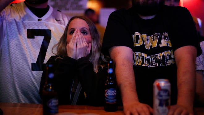 Abagail Avery of Altoona reacts Saturday Dec. 5, 2015, as she watched the Iowa Hawkeyes fall to Michigan State during a Big 10 championship watch party at Beechwood Lounge in Des Moines.