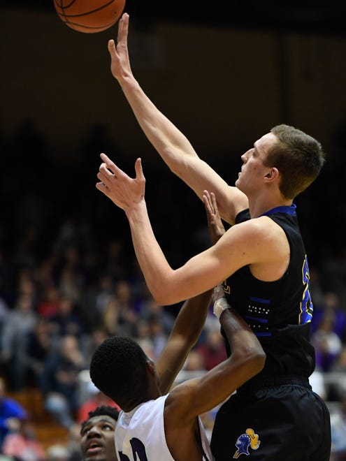 Castle’s Jack Nunge shoots over Ben Davis’ Joshua Brewer as Castle plays Ben Davis in the Boys’ Semi-State Basketball Tourney at Seymour High School Saturday, March 18, 2017.