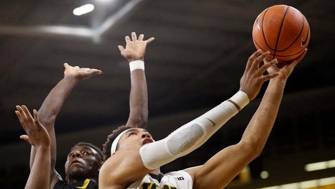 Iowa forward Cordell Pemsl (35) drives to the basket past Alabama State guard Tobi Ewuosho during the first half of an NCAA college basketball game, Sunday, Nov. 12, 2017, in Iowa City, Iowa. Poems scored 15 points as Iowa won 92-58.
