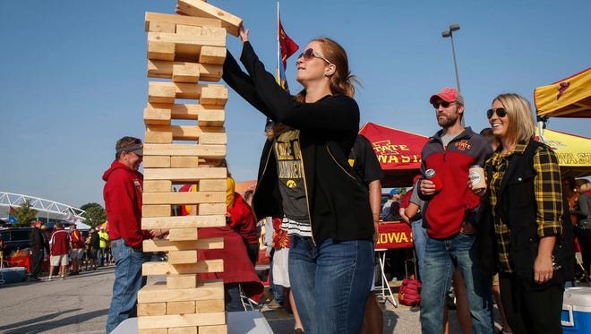 Marie Mueller of Davenport stacks a Jenga board while tailgating prior to the CyHawk Series game between Iowa and Iowa State on Saturday, Sept. 9, 2017, at Jack Trice Stadium in Ames, Iowa.