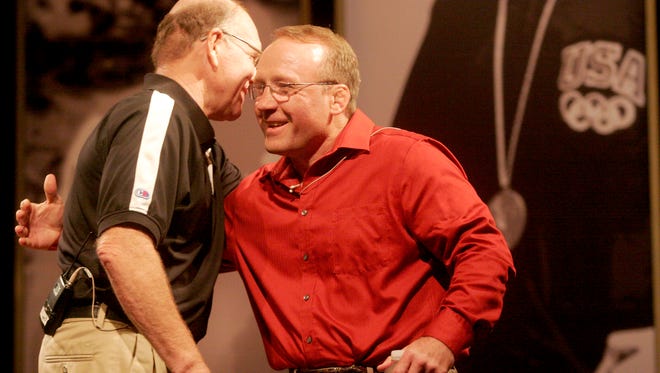 Former Gable wrestler Barry Davis embraces his former coach during "This Is Your Life, Dan Gable" at the Coralville Marriott Hotel and Convention Center kicking off FryFest 2011 on Sept. 2 in Coralville.