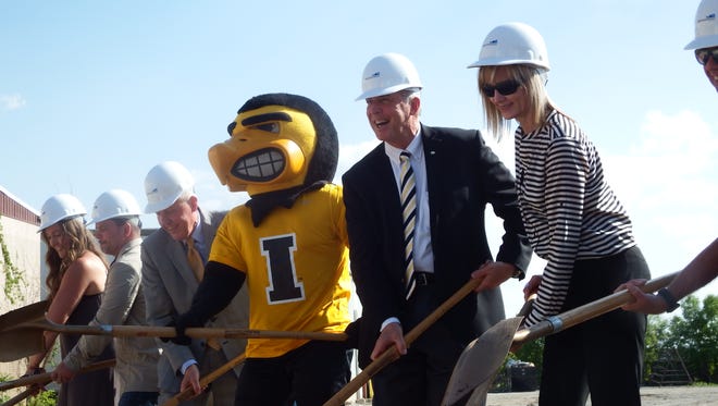 Herky the Hawk and UI athletic director Gary Barta, right of Herky, shovel dirt  at the groundbreaking of the the Coralville arena on May 16, 2018.