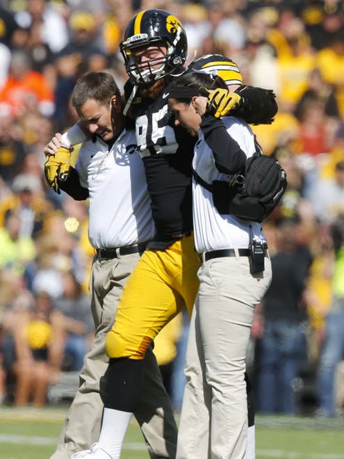 Iowa defensive end Drew Ott is helped off the field after injuring his right knee against Illinois on Oct. 10. He had surgery on Oct. 22.
