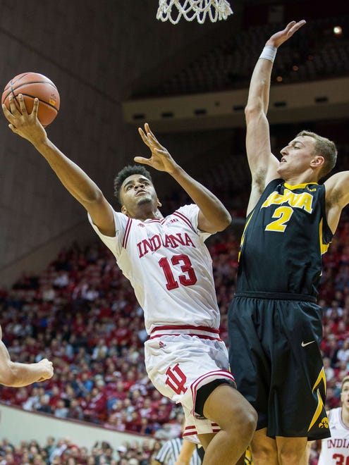 Dec 4, 2017; Bloomington, IN, USA; Indiana Hoosiers forward Juwan Morgan (13) shoots the ball while Iowa Hawkeyes forward Jack Nunge (2) defends in the first half of the game at Assembly Hall. Mandatory Credit: Trevor Ruszkowski-USA TODAY Sports