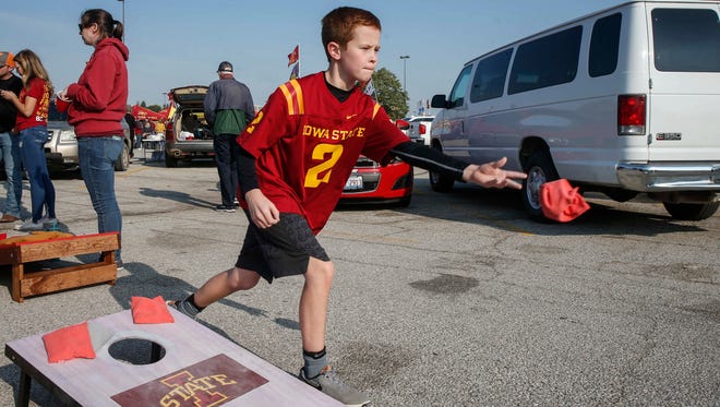 Wyatt Pink, 10, of Ames tosses a bean bag while tailgating prior to the CyHawk Series game between Iowa and Iowa State on Saturday, Sept. 9, 2017, at Jack Trice Stadium in Ames, Iowa.