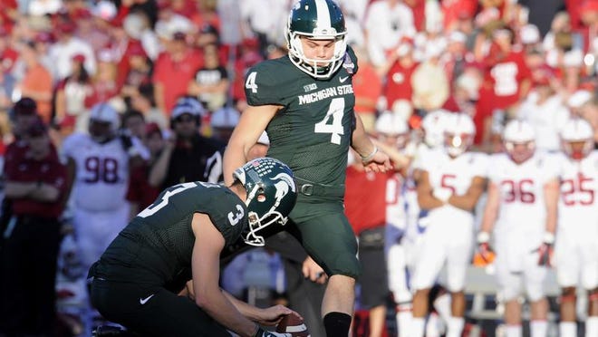 MSU kicker Michael Geiger kicks a field goal out of the hold of punter Mike Sadler during the Rose Bowl in January.