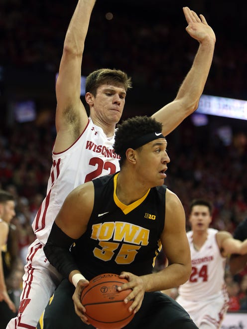 Mar 2, 2017; Madison, WI, USA; Iowa Hawkeyes forward Cordell Pemsl (35) attempts to pass as Wisconsin Badgers forward Ethan Happ (22) defends during the first half at the Kohl Center.