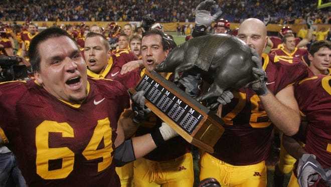 Minnesota players celebrate with the Floyd of Rosedale, Saturday November 18,2006 at the Metrodome in Minneapolis, Minn. after defeating Iowa 34-24.