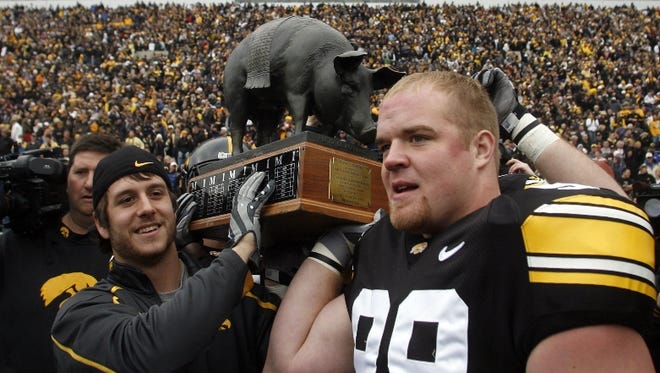 Iowa's Jayme Murphy and Chad Geary carry the Floyd of Rosedale off the field after the 12-0 victory over Minnesota, Saturday, Nov. 21, 2009, at Kinnick Stadium, in Iowa City, Iowa.