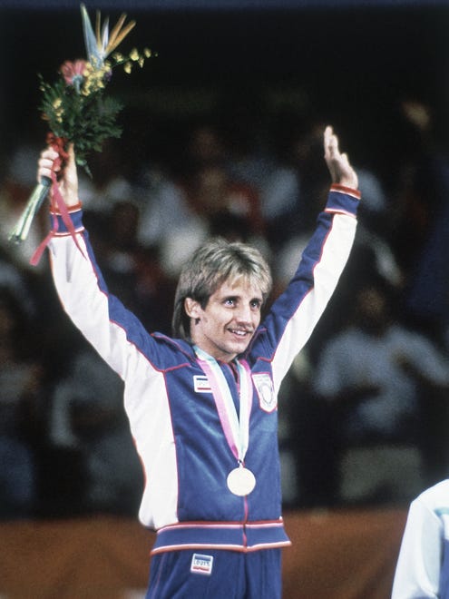 American wrestler Randy Lewis on the podium after winning the gold medal in the Men's 57 kilogram Freestyle Wrestling event at the Summer Olympic Games in Los Angeles, California, USA on August 10, 1984.