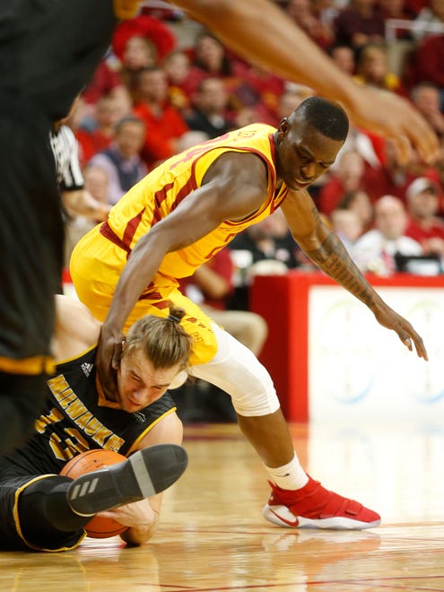 Iowa State guard Terrence Lewis (24) scrambles for the ball with Milwaukee guard August Haas (13) Monday, Nov. 13, 2017, during their game at Hilton Coliseum in Ames.