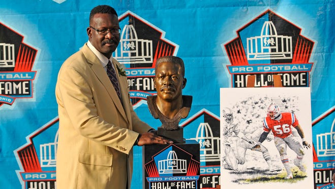 From 2008: New England Patriots former linebacker Andre Tippett with his bust and official portrait during his enshrinement into the Pro Football Hall of Fame at Fawcett Stadium.
