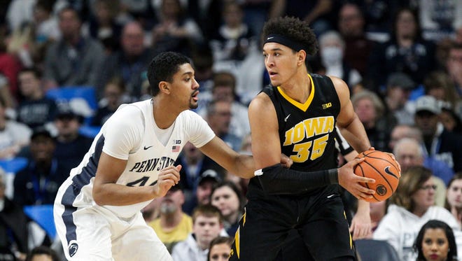 Iowa Hawkeyes forward Cordell Pemsl (35) holds the ball as Penn State Nittany Lions forward Julian Moore (44) defends during the first half at Bryce Jordan Center. Penn State defeated Iowa 82-58.