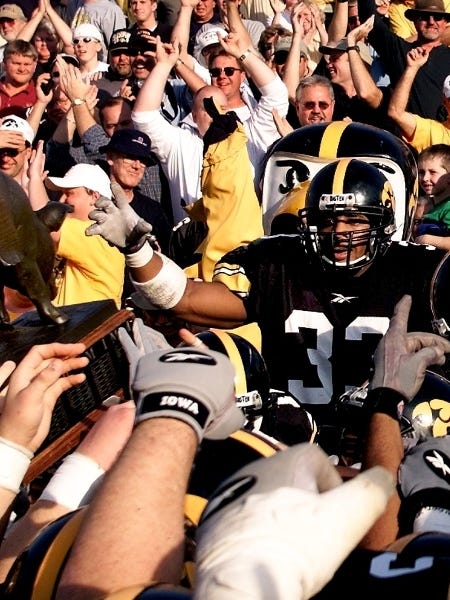 Bob Sanders (33) joins an emotional postgame ceremony in 2001 as the Hawkeyes reclaimed the Floyd of Rosedale trophy after a 42-24 victory over Minnesota for Iowa's sixth win this season.