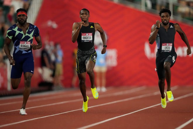 FILE - In this June 27, 2021, file photo, Noah Lyles, right, wins the final in the men's 200-meter run ahead of Kenny Bednarek, left, in second and Erriyon Knighton, in third, at the U.S. Olympic Track and Field Trials in Eugene, Ore. Lyles, the 200-meter world champion, will lead a strong contingent of American sprinters that includes teenager Knighton at the upcoming Tokyo Games. (AP Photo/Ashley Landis, File)