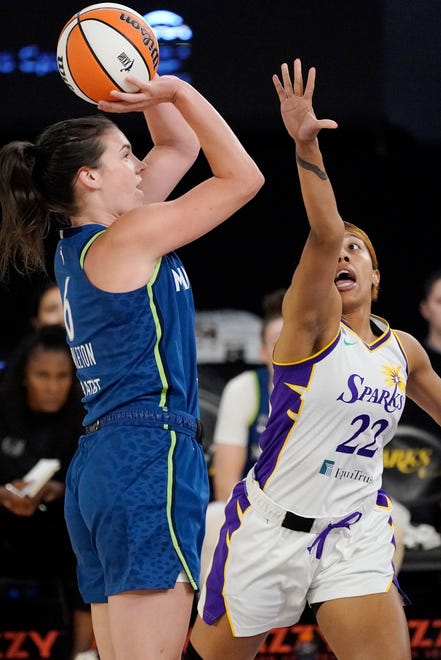 Minnesota Lynx forward Bridget Carleton, left, shoots as Los Angeles Sparks guard Arella Guirantes defends during the first half of a WNBA basketball game Sunday, July 11, 2021, in Los Angeles. (AP Photo/Mark J. Terrill)