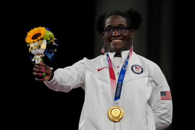 Gold medalist, United States Tamyra Marianna Stock Mensah celebrates on the podium during the medal ceremony for the women's 68kg Freestyle wrestling at the 2020 Summer Olympics, Tuesday, Aug. 3, 2021, in Chiba, Japan. (AP Photo/Aaron Favila)