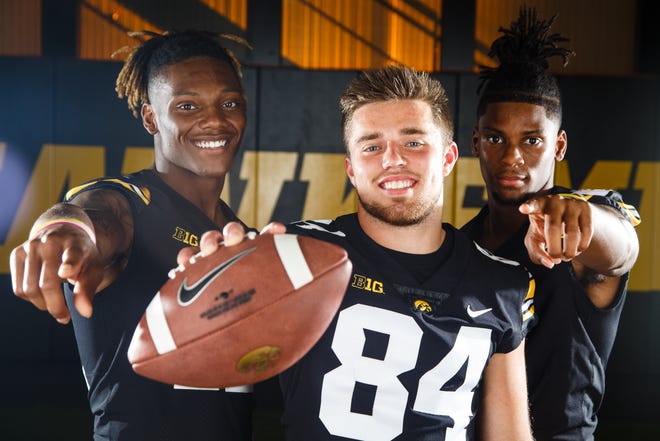 Iowa's Brandon	Smith, left, Nick Easley, center, and Ihmir	Smith-Marsette, right, pose for a photo during the Iowa Football media day on Friday, Aug. 10, 2018 in Iowa City.