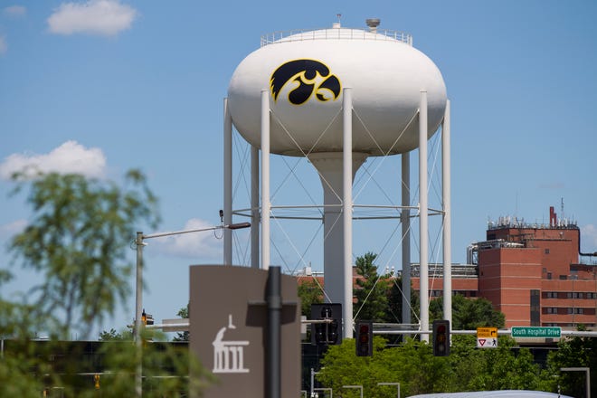 Traffic flows past the recently painted water tower along Hawkins Drive while construction continues during a renovation project at Kinnick Stadium on Tuesday, July 17, 2018, in Iowa City, Iowa.