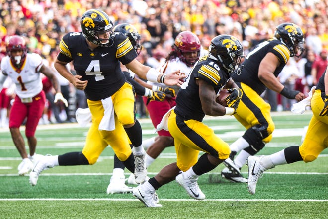 Iowa quarterback Nate Stanley (4) hands off a ball to Iowa running back Mekhi Sargent (10) during the Cy-Hawk NCAA football game on Saturday, Sept. 8, 2018, at Kinnick Stadium in Iowa City.