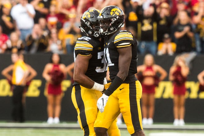 Iowa defensive back Michael Ojemudia (11) celebrates a stop with teammate Djimon Colbert (32) during the Cy-Hawk NCAA football game on Saturday, Sept. 8, 2018, at Kinnick Stadium in Iowa City.