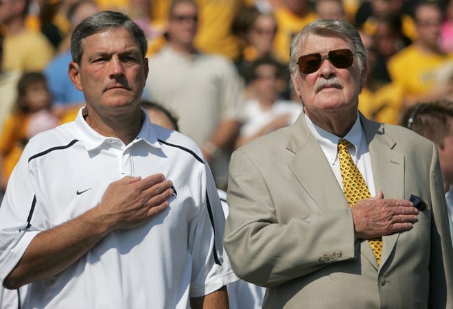 Iowa head coach Kirk Ferentz, left, and former Iowa coach Hayden Fry stand together during the National Anthem Sept. 5, 2009 in Iowa City.  Fry was an honorary team captain for the Hawkeyes' season opener.