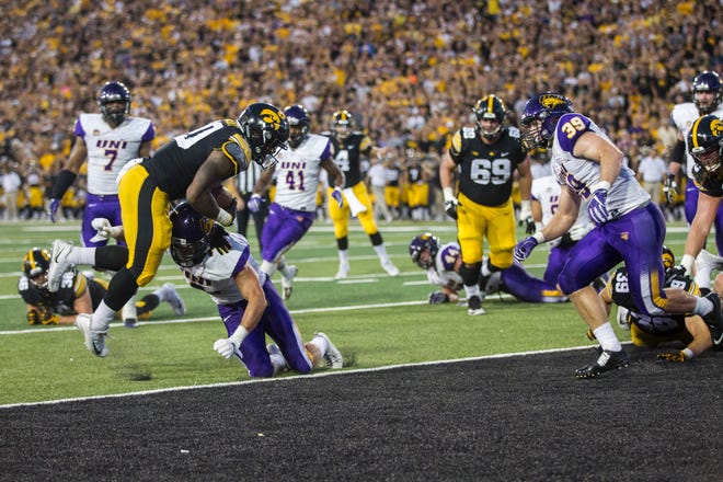 Iowa running back Mekhi Sargent (10) collides with Northern Iowa defensive back Xavior Williams (9) during an NCAA football game on Saturday, Sept. 15, 2018, at Kinnick Stadium in Iowa City.