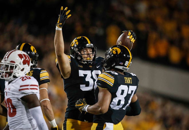 Iowa tight end T.J. Hockenson celebrates with teammate Noah Fant after pulling in a catch for a first down against Wisconsin on Saturday, Sept. 22, 2018, at Kinnick Stadium in Iowa City.