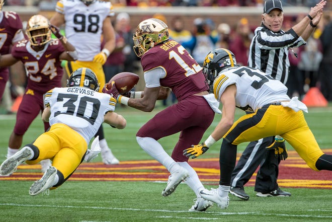 Oct 6, 2018; Minneapolis, MN, USA; Minnesota Golden Gophers wide receiver Rashod Bateman (13) catches a tipped pass in between defense from Iowa Hawkeyes defensive back Jake Gervase (30) and defensive back Riley Moss (33) in the first half at TCF Bank Stadium. Mandatory Credit: Jesse Johnson-USA TODAY Sports