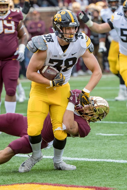 Oct 6, 2018; Minneapolis, MN, USA; Iowa Hawkeyes tight end T.J. Hockenson (38) catches a touchdown pass against Minnesota Golden Gophers defensive back Jacob Huff (2) in the first quarter at TCF Bank Stadium. Mandatory Credit: Jesse Johnson-USA TODAY Sports