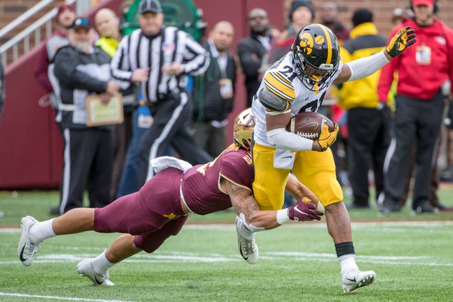 Oct 6, 2018; Minneapolis, MN, USA; Iowa Hawkeyes running back Ivory Kelly-Martin (21) runs the ball as Minnesota Golden Gophers defensive back Jacob Huff (2) makes a tackle in the first quarter at TCF Bank Stadium. Mandatory Credit: Jesse Johnson-USA TODAY Sports