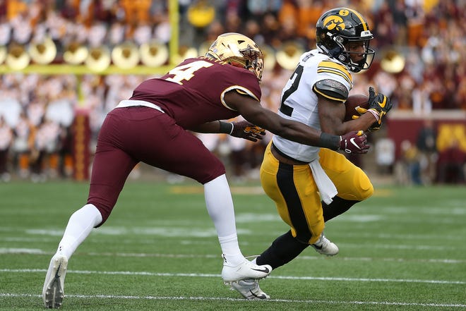 Iowa wide receiver Brandon Smith controls the ball against Minnesota's defensive back Terell Smith during an NCAA college football game Saturday, Oct. 6, 2018, in Minneapolis. (AP Photo/Stacy Bengs)
